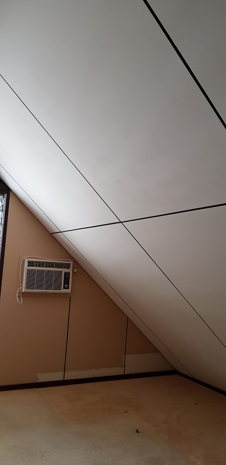 Raked ceiling freshly sheeted with plasterboard and the joints set